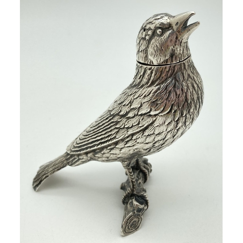 A late 19th Century German Silver large novelty pepper in the form of a songbird on a branch. With marks for Neresheimer, Hanau and sponsor's mark of Berthold Muller. Approx. 10cm tall x 11.5cm long and weighs approx. 62g.