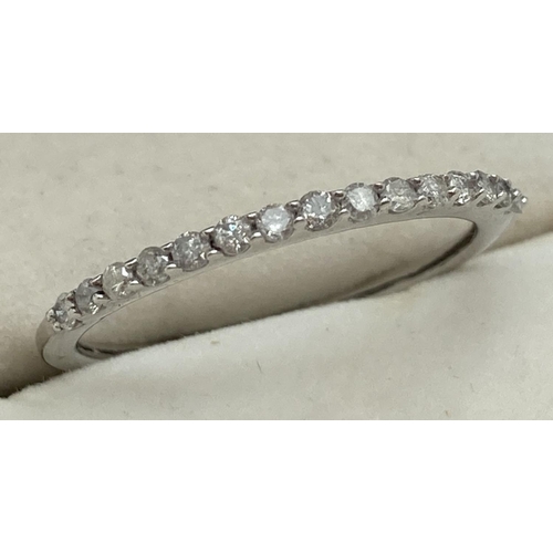 1096 - A 9ct white gold and diamond half eternity ring set with 15 round brilliant cut diamonds. Diamond we... 