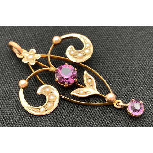 1017 - An Art Nouveau 9ct gold pendant set with seed pearls, central purple coloured stone and drop pendant... 