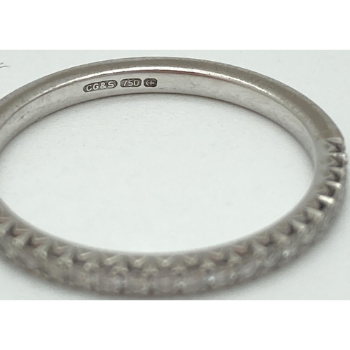 1028 - An 18ct white gold, diamond set half eternity ring. Fully hallmarked inside band. Ring size L, total... 