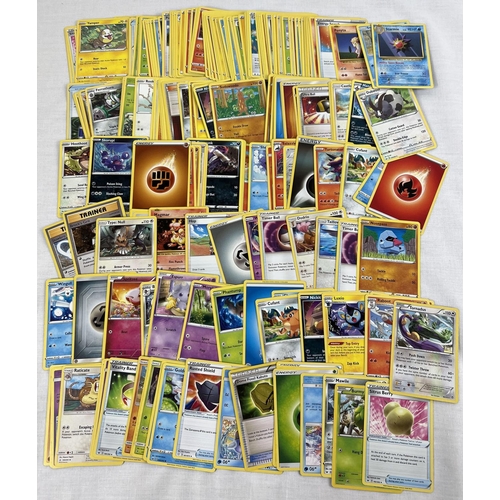 39 - 200 assorted modern pokemon trading cards.