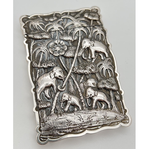 An unmarked antique Anglo-Indian silver card case with highly detailed embossed decoration to both sides. Featuring elephants and wild cats in jungle scenes. Engraved 'Dennie' on edge. Tested as over 80% silver with XRF analyser by Juels Ltd, Norwich. Approx. 11cm x 7.5cm, total weight approx. 141.6g.