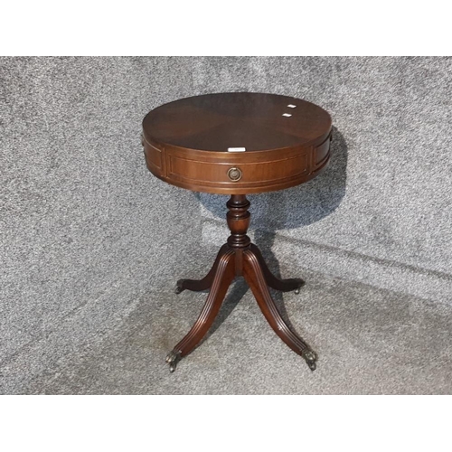 A reproduction mahogany drum table by N Norman Ltd two single drawers and two dummy drawers 49.5cm diameter