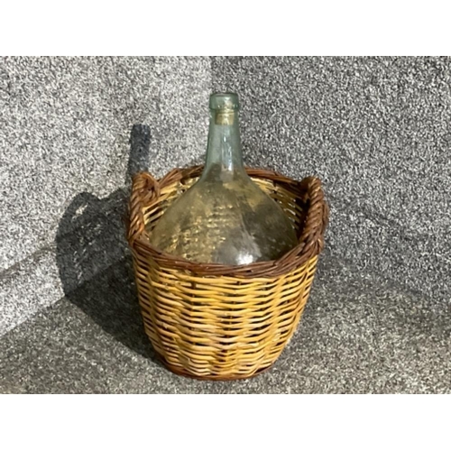 22 - Large glass carboyand wicker basket