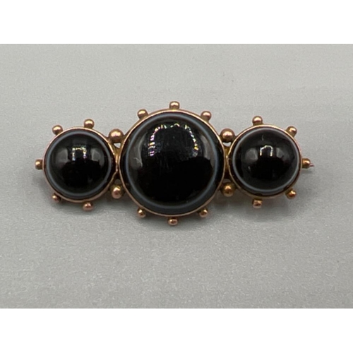 Antique ladies 9ct rose gold brooch. Featuring 3 round black stones. 3.9g