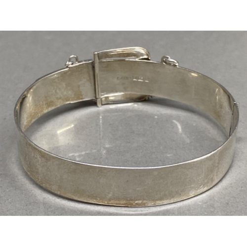 24 - 1970s hallmarked silver bangle in the form of a belt buckle, 24.1g