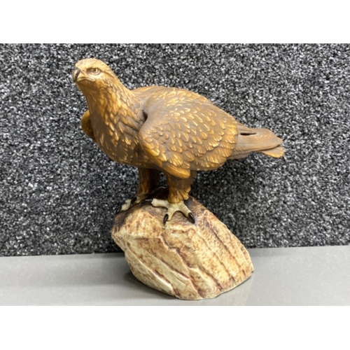 33 - Eagle ornament on rock signed Tommocloe to the base (damage to back of wing)