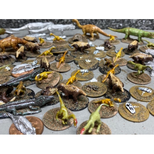 59 - Tub containing a variety of lead dinosaur game pieces, (Triassic & Jurassic) including Postosuchus, ... 