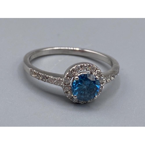 34 - 18ct white gold ring comprising of a 0.60ct blue diamond surrounded by a total of 0.30cts of diamond... 
