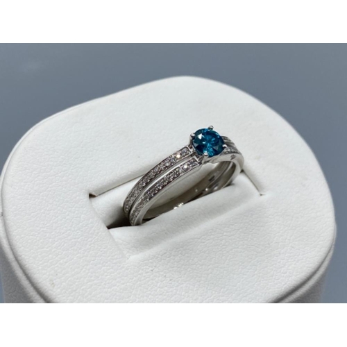 35 - 18ct White Gold Double Banded Ring with a 0.41ct coloured diamond centre stone surrounded by a total... 