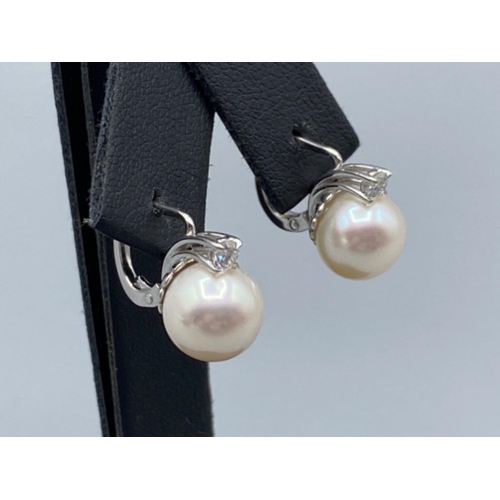56 - 18ct White Gold Slight Drop Pearl and Diamond Earrings 0.21ct diamonds in total weighing 5.10 grams
