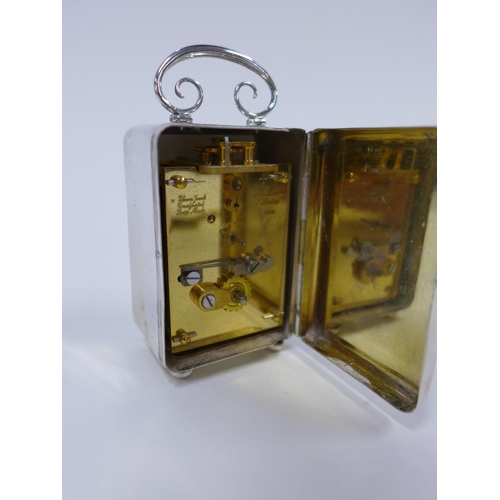 15 - Mathew Norman silver cased miniature clock, London 1981, 9cm including handle