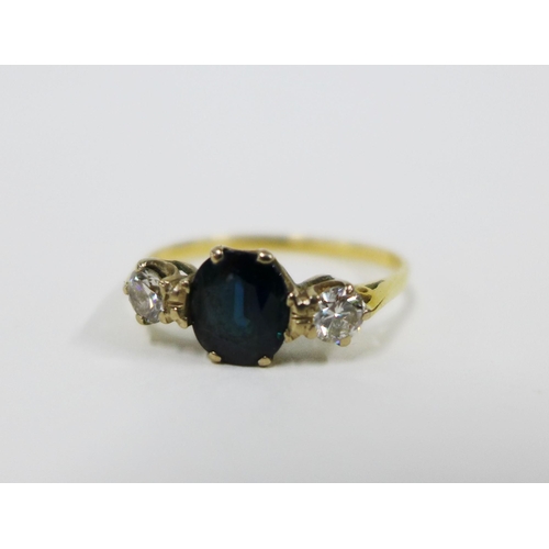 71 - Sapphire and diamond three stone ring, with a central oval sapphire flanked by bright cut diamonds, ... 