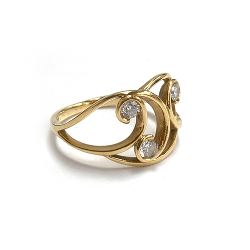 An 18ct gold Art Nouveau ring set with three brilliant cut diamonds, size P 1/2, 3.8g