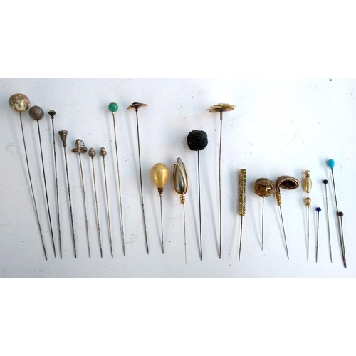 21 - A collection of 21 hat pins to include two white metal in the form of acorns, a hallmarked silver th... 