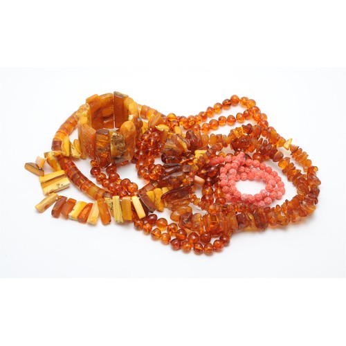 23 - Two graduated polished amber bead necklaces, both approximately 94cm long; together with further amb... 