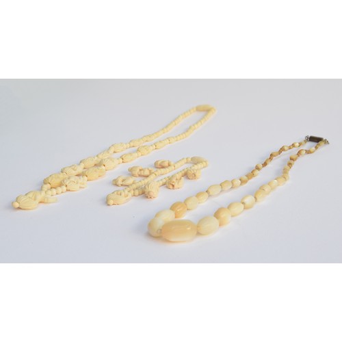 27 - A mother of pearl graduated bead necklace with barrel clasp, 50cmL; together with a carved bone elep... 
