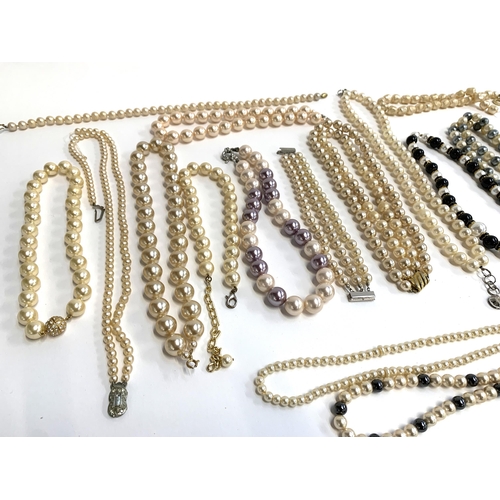 38 - A large quantity of mainly faux pearl necklaces, to include 2x two strand faux pearl chokers with ha... 