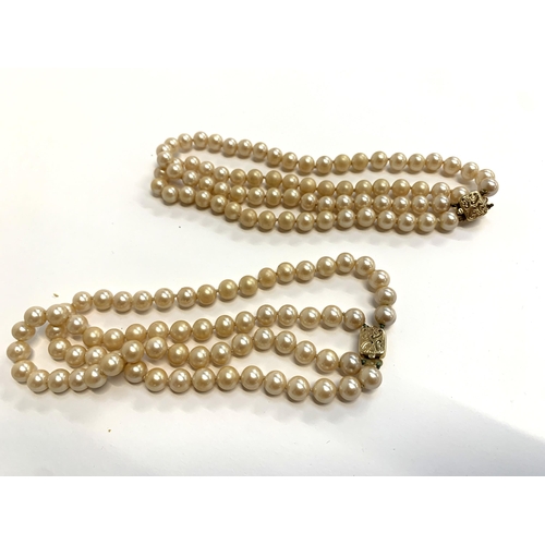 38 - A large quantity of mainly faux pearl necklaces, to include 2x two strand faux pearl chokers with ha... 