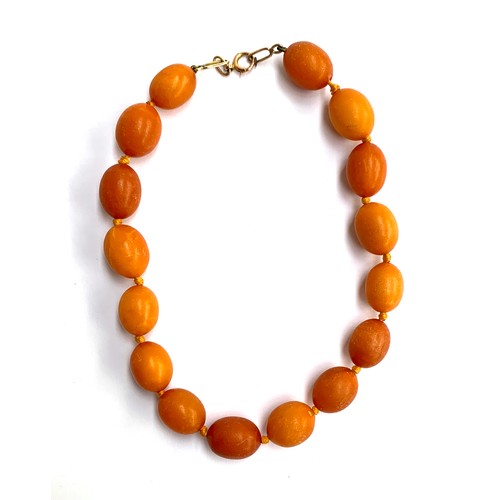 10 - An amber necklace, 9ct gold clasp, comprising of 16 beads, knotted, 40cmL, approx. 43g