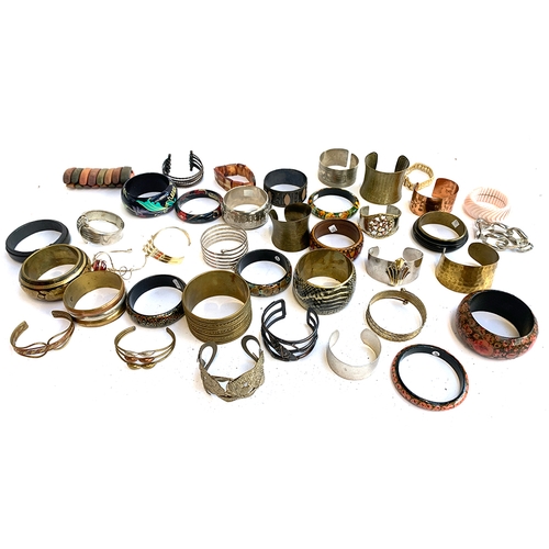 21A - A large quantity of bangles, approx. 39, to include white metal, gold plated etc
