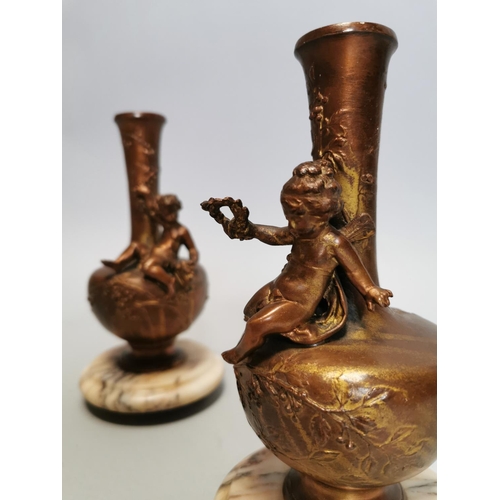 53 - Pair of spelter and marble vases decorated with foliage and a seated cherub { 21cm H X 10cm Dia. }