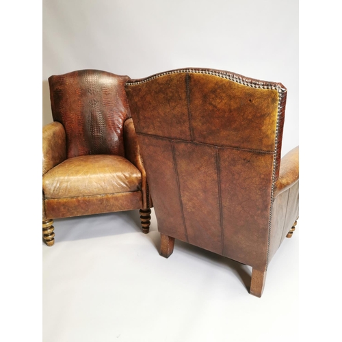 59 - Pair of leather upholstered armchairs raised on turned legs { 94cm H X 75cm W X 84cm D }.