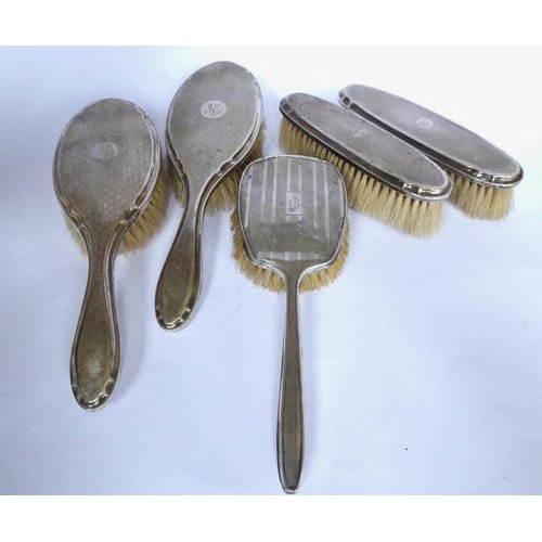 11 - Four piece engine turned design silver dressing table set and another brush. Set  Birmingham 1925.