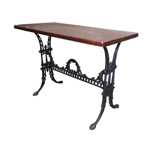 29 - Decorative Cafe table the wooden top raised on cast iron base {72cm H x 100cm W x 52cm D}