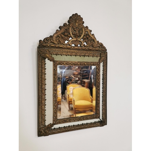 13 - 19th C. embossed brass cushion mirror {70 cm H x 43 cm W}.