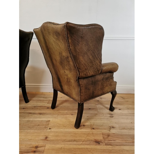 39 - Pair of early 20th C. hand died brown leather deep buttoned wing back chairs with brass studs raised... 