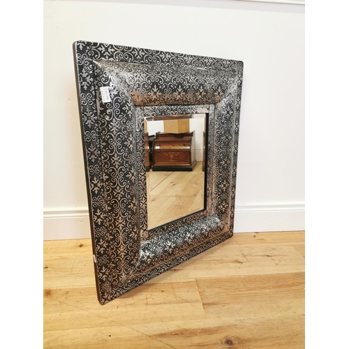 50 - Embossed metal framed wall mirror. {77 cm H x 66 cm W}.