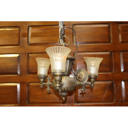 13 - Polished metal three branch chandelier with clear glass shades {40 cm H x 50 cm Dia.}.