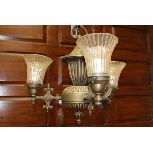 14 - Polished metal three branch chandelier with clear glass shades {40 cm H x 50 cm Dia.}.