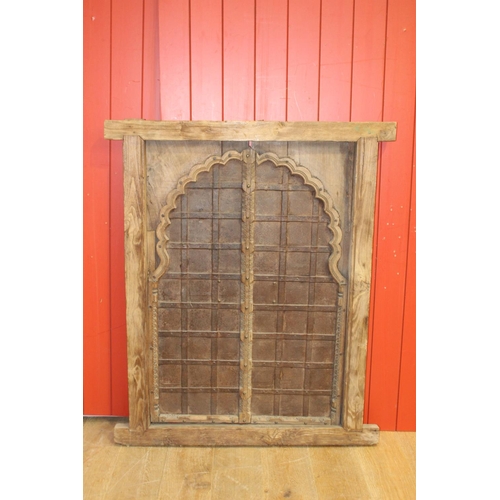 19 - Pitch pine window frame with metal insert in the Moroccan style {128 cm H x 108cm W x 5 cm D}.