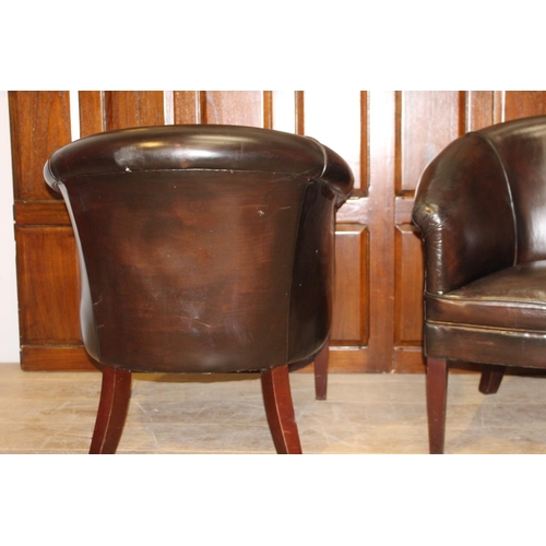 28 - Pair of dark brown leather upholstered tub chairs {78 cm H x 70 cm W x 47 cm D}.