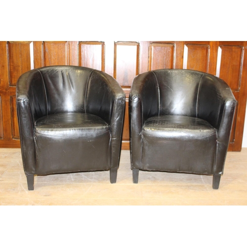 29 - Pair of black leather tub chairs {78 cm H x 70 cm W x 47 cm D}.