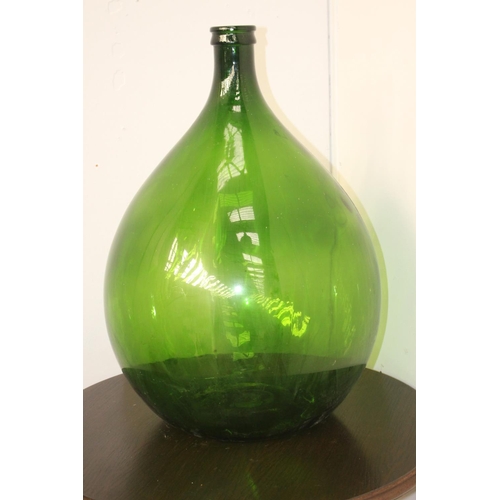 57 - Green glass wine bottle {66 cm H x 42 cm Dia.}.
