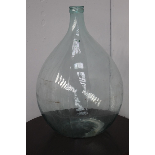 58 - Clear glass wine bottle {66 cm H x 42 cm Dia.}.