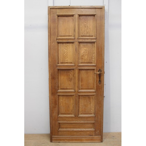 23 - Oak door with nine panels and mounted with brass handles {200 cm H x 80 cm W x 5 cm D}.