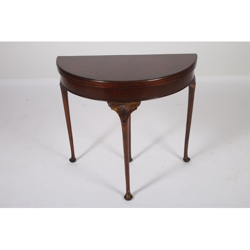 34 - A GEORGIAN DESIGN MAHOGANY CROSS BANDED FOLD OVER CARD TABLE of demilune outline with baize lined in... 