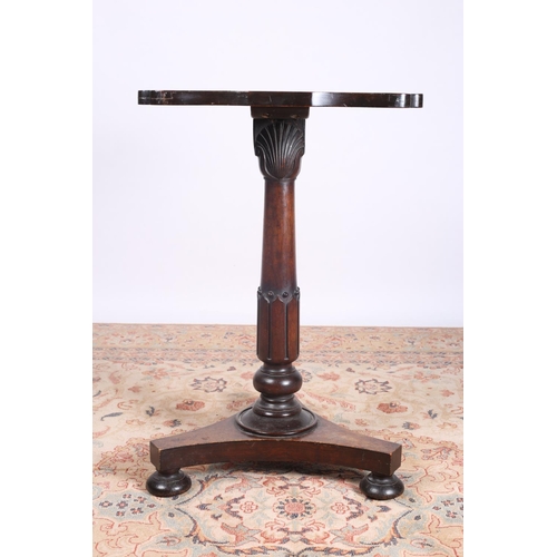 26 - A REGENCY ROSEWOOD OCASSIONAL TABLE of serpentine outline the shaped top with carved scrolls to the ... 