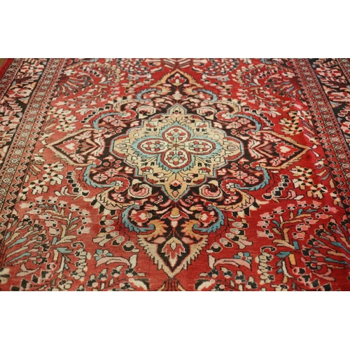 3 - A LILIAN WOOL RUG the wine ground with central stylized floral panel within a conforming border 235c... 