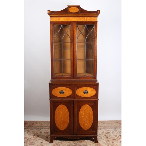 41 - A SHERATON DESIGN MAHOGANY AND SATINWOOD INLAID SECRETAIRE LIBRARY BOOKCASE the shaped cornice above... 