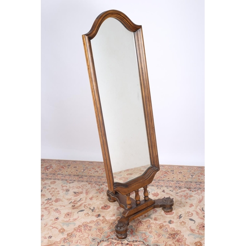 53 - A STAINED BEECHWOOD CHEVAL MIRROR the shaped plate within a moulded frame on triform base 146cm (h) ... 