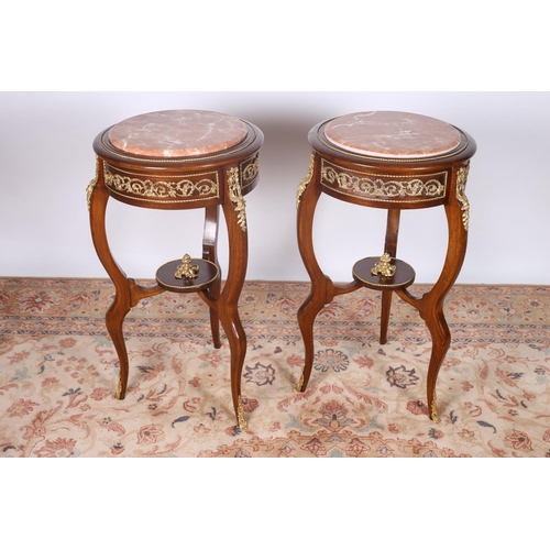 54 - A PAIR OF CONTINENTAL STAINED BEECHWOOD AND GILT BRASS MOUNTED MARBLE TABLES each of circular outlin... 