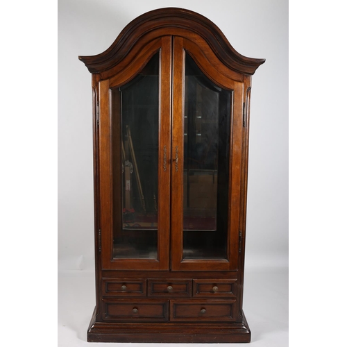 57 - A CONTINENTAL MAHOGANY DISPLAY CABINET the dome shaped hood above a pair of shaped bevelled glazed d... 