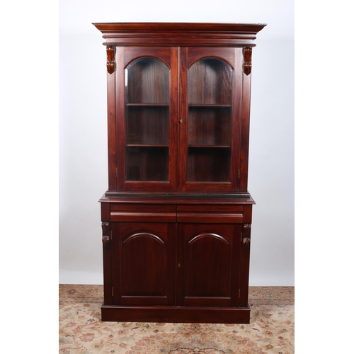 59 - A VICTORIAN DESIGN MAHOGANY LIBRARY BOOKCASE the moulded cornice above a pair of bevelled glass door... 