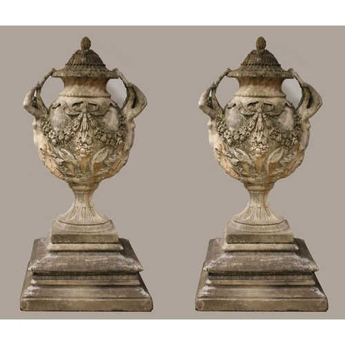 7 - A VERY FINE AND IMPRESSIVE PAIR OF SANDSTONE URNS each of ovoid tapering form hung with ribbon tied ... 