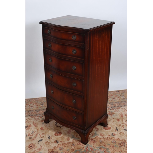 30 - A GEORGIAN DESIGN MAHOGANY TALLBOY of serpentine outline the shaped top above seven long drawers bet... 